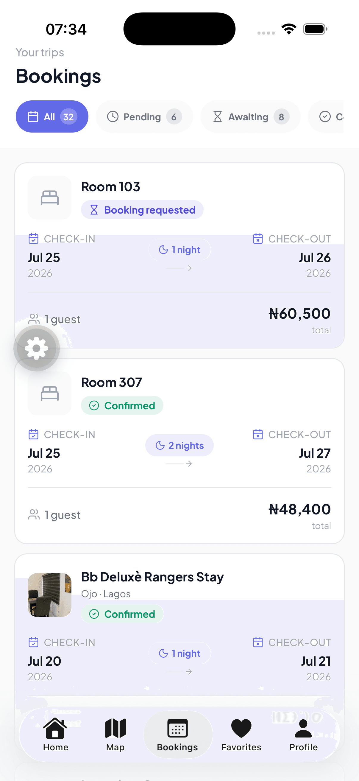 Roomly app bookings screen listing trips with their booking status, check-in and check-out dates and totals